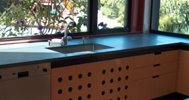 Modern kitchen counter with wood base cabinet